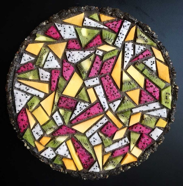 caption: Black sesame tart with kiwi, dragon fruit and mango.