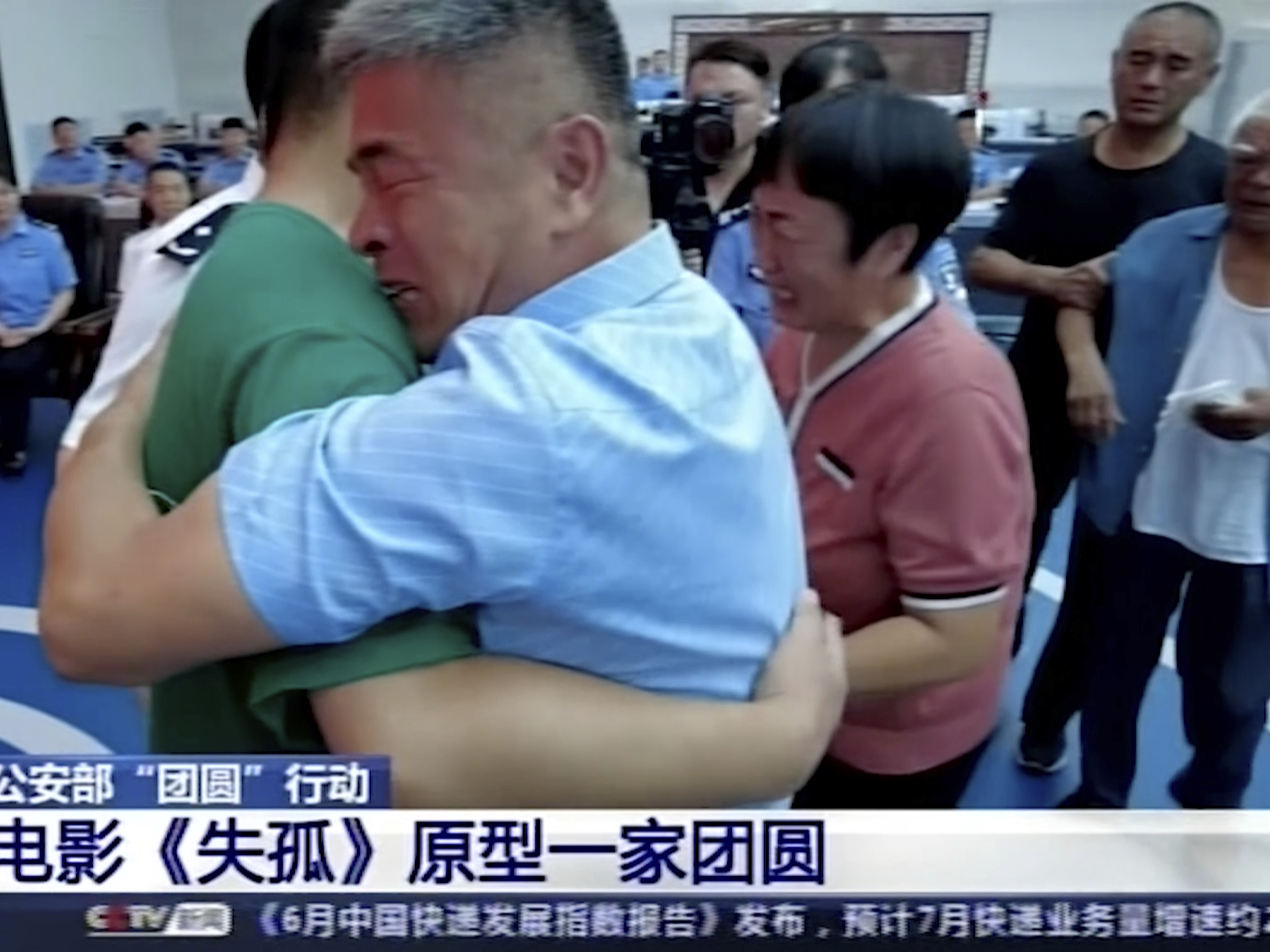 caption: Guo Gangtang, right, embraces his son Guo Xinzhen during a reunion after 24 years in Liaocheng, in Central China's Shandong province.