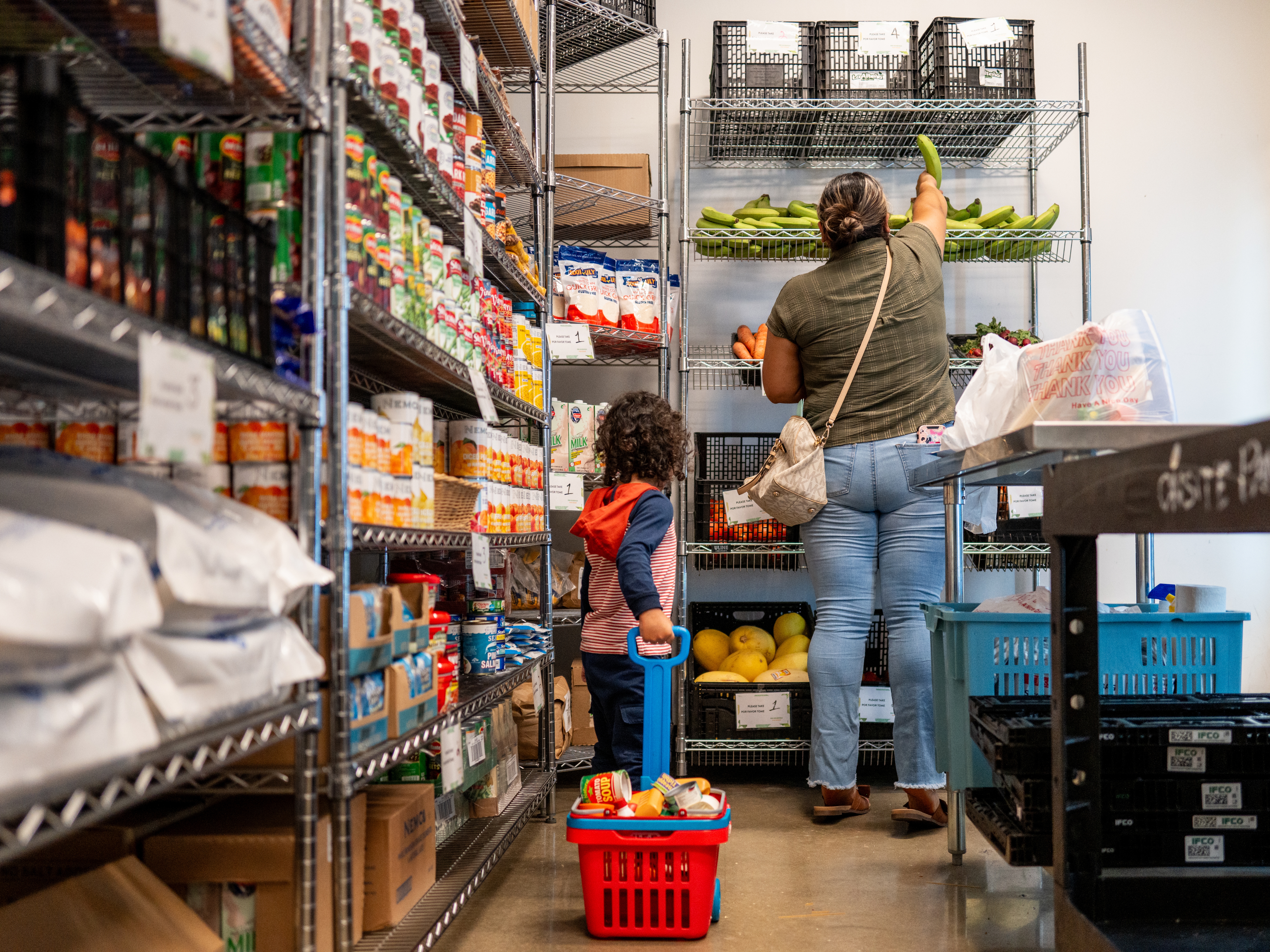 caption: A family gathers food in the community pantry at the Central Texas Food Bank on March 26 in Austin, Texas. The Trump administration's USDA is ending a yearly food insecurity survey.