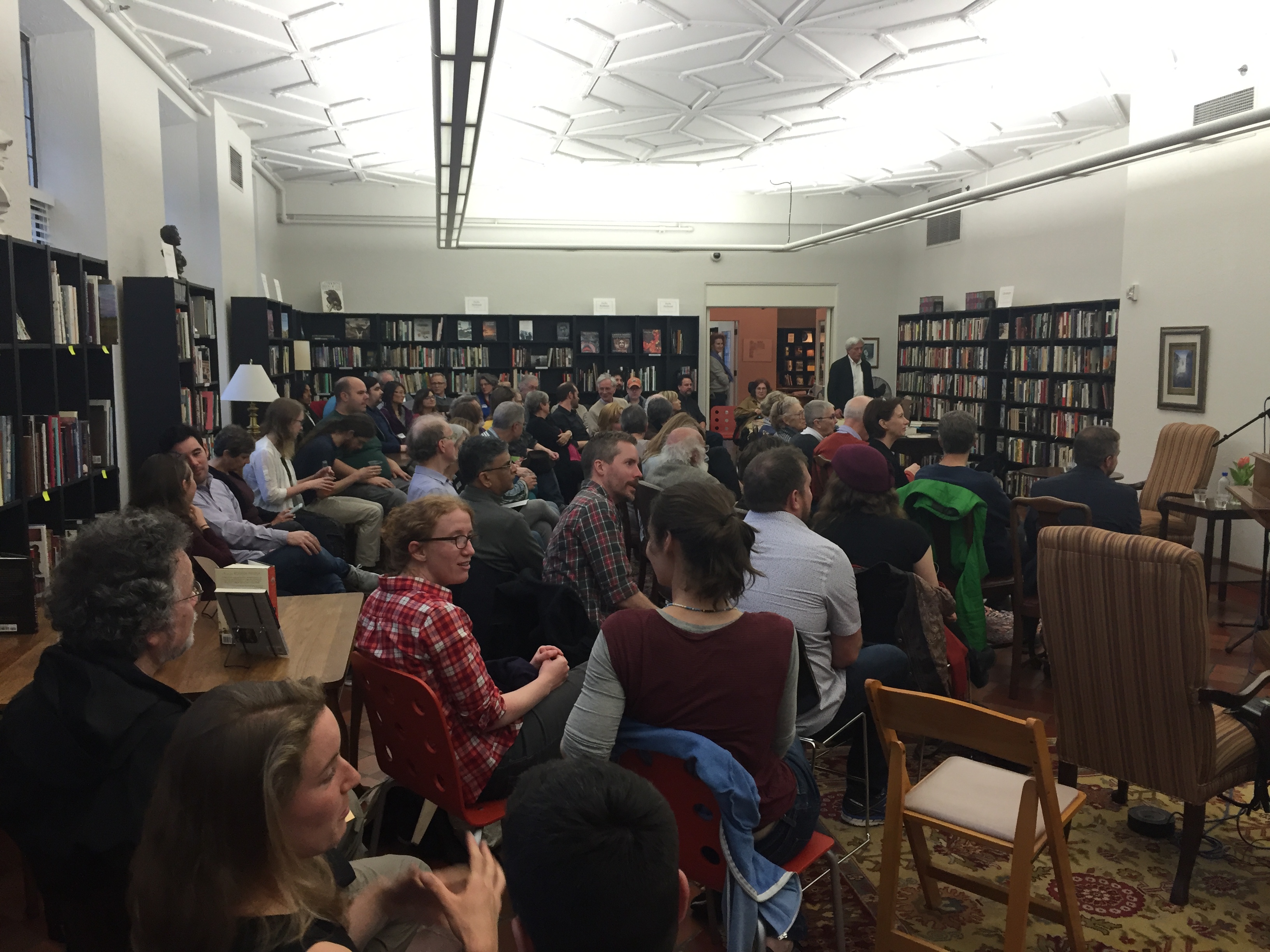 caption: Audience awaits the Poets Three reading at Folio- The Seattle Athenaeum
