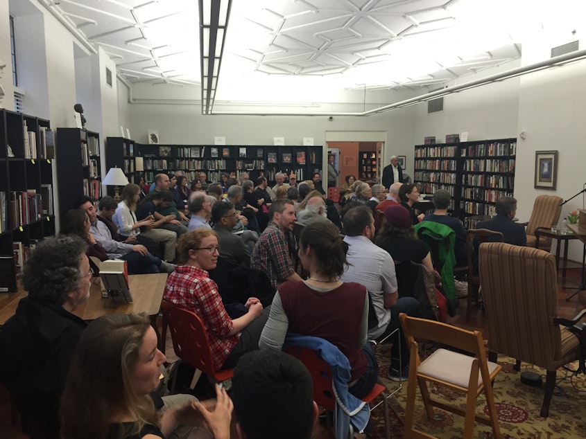 caption: Audience awaits the Poets Three reading at Folio- The Seattle Athenaeum