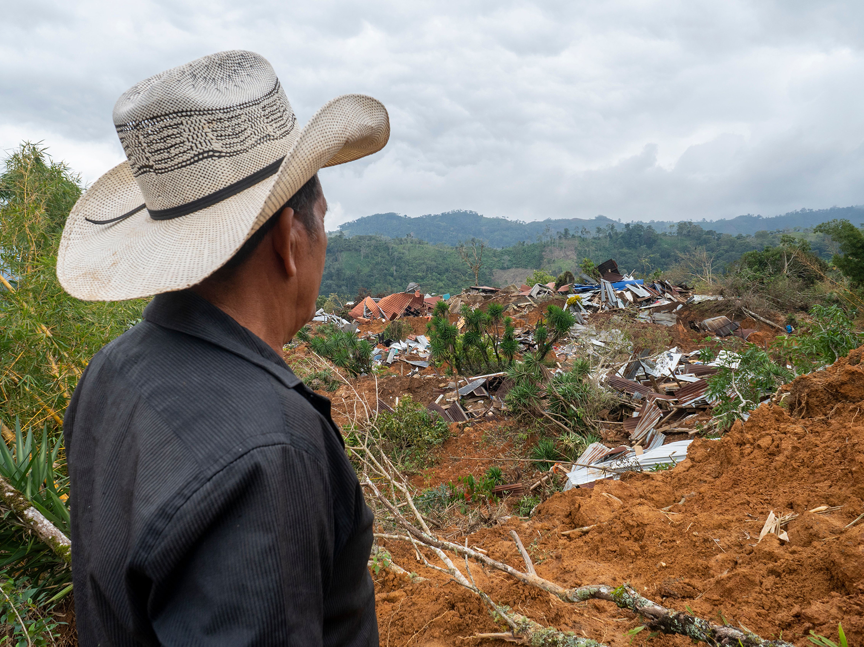 caption: The two hurricanes destroyed bridges, roads, schools, health clinics and homes. This photo was taken in Proteccion in the Santa Barbara department on December 11.