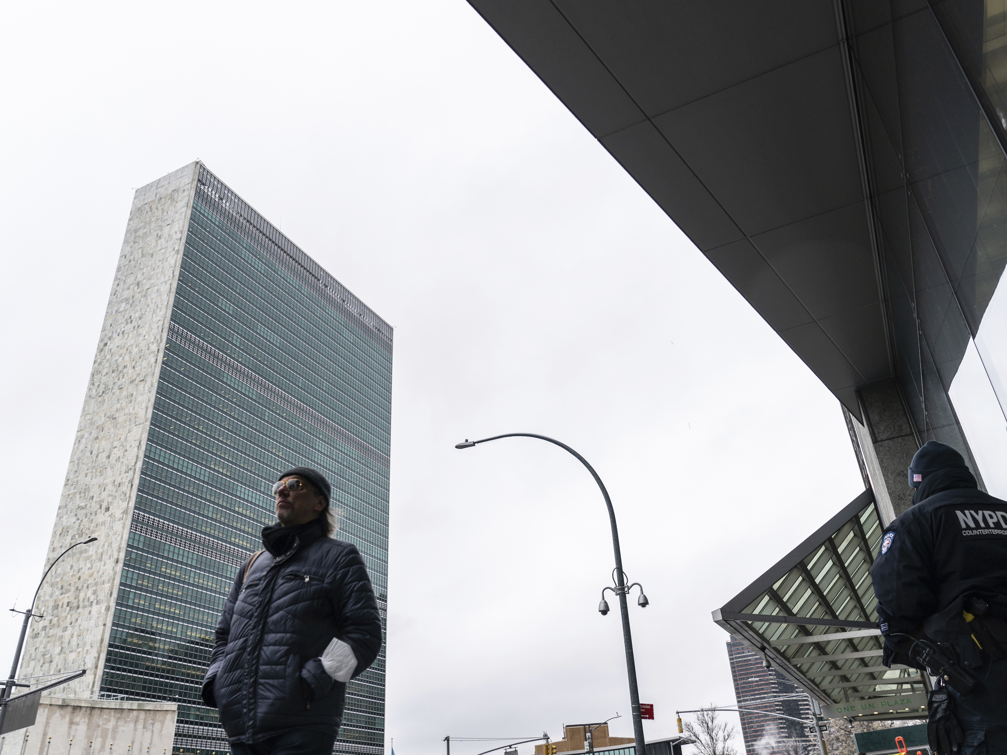 caption: A pedestrian walks past outside U.N. headquarters, Friday, Feb. 25, 2022, in New York.