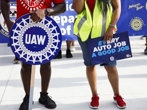 caption: United Auto Workers members and others gather for a rally after marching in the Detroit Labor Day Parade in Detroit on Sept. 4, 2023. Only hours remain before UAW contracts with the Big 3 automakers expire just before midnight.