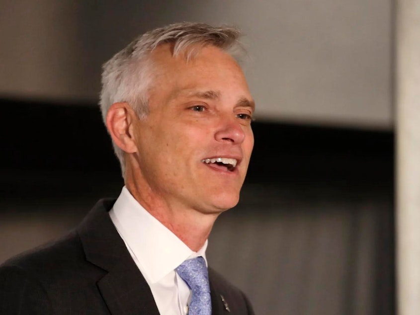 caption: In light of several recent incidents involving alleged racial discrimination toward its passengers, American Airlines CEO Robert Isom says he is taking immediate action to “rebuild trust” within the company. Here, Isom speaks at a news conference in Seattle on Feb. 13, 2020 about the company's new partnership with Alaska Airlines.