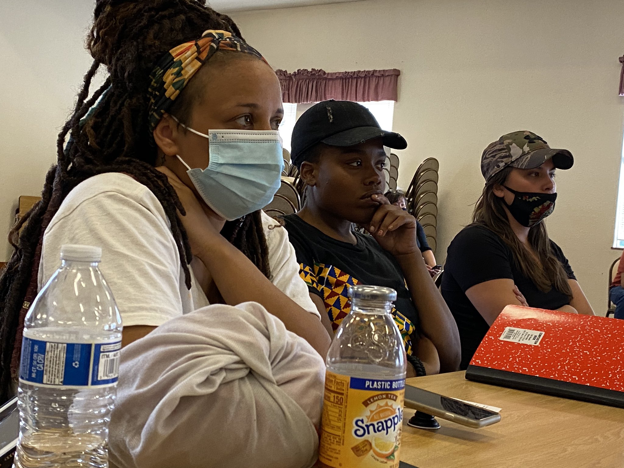 caption: Angelica Campbell, center, meets with Seattle city leaders and other activists, during the summer of 2020. 