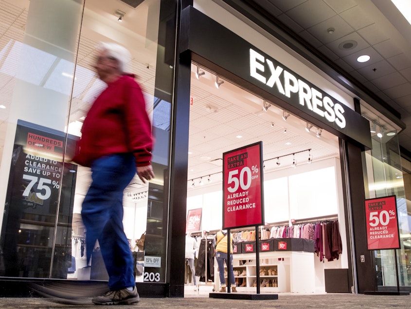 caption: An Express store promotes deep sales in Valley West Mall in Iowa, in January 2020.
