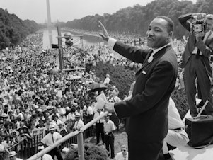 caption: Martin Luther King Jr. stands in front of a crowd in Washington, D.C.