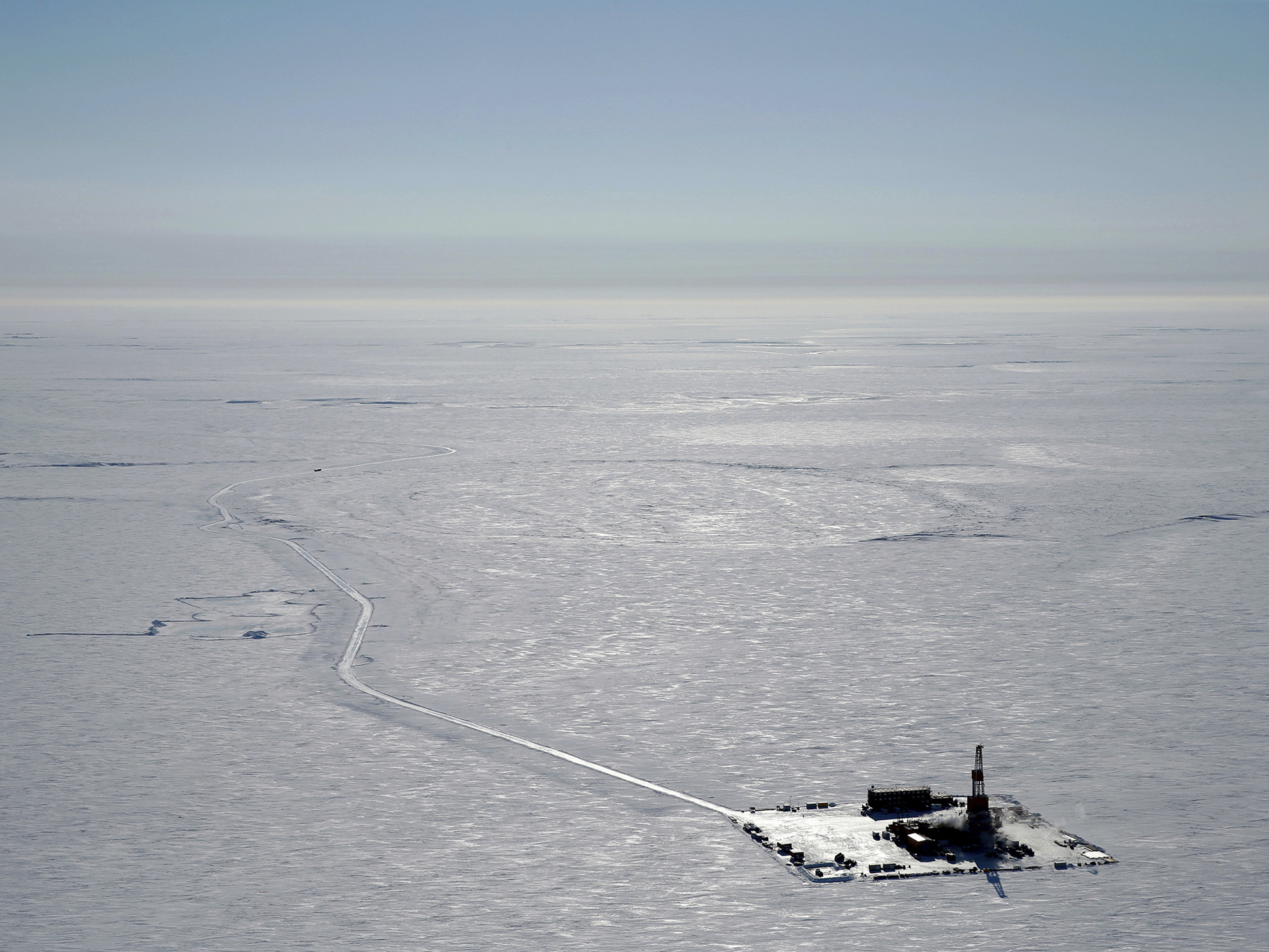 caption: This 2019 aerial photo provided by ConocoPhillips shows an exploratory drilling camp at the proposed site of the Willow oil project on Alaska's North Slope.