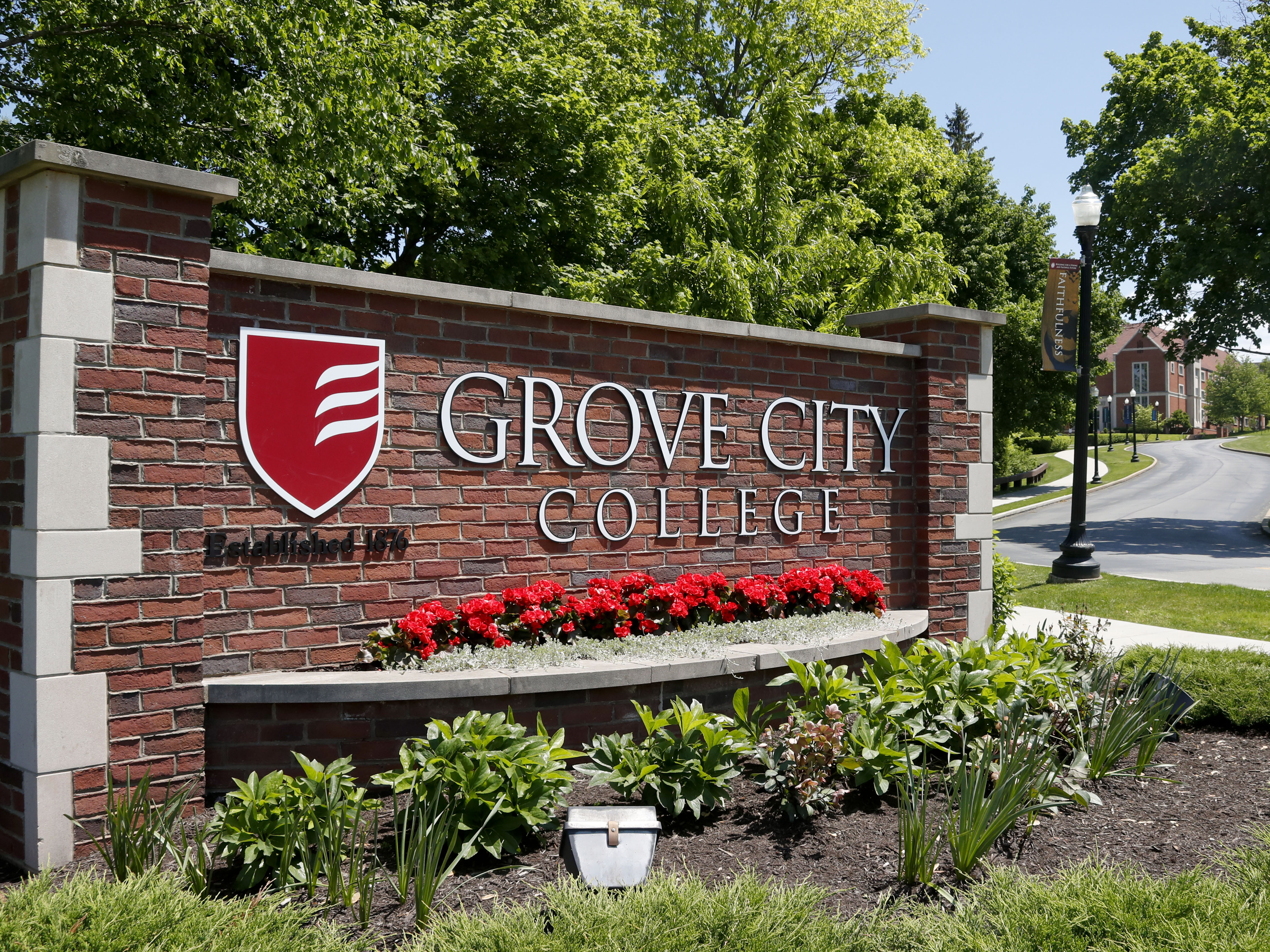 caption: A sign marks the main entrance to the campus of Grove City College in Grove City, Pa.