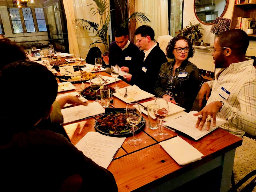 caption: Dy Johnson and Rachel Oppenheim talk over dinner at KUOW's first Pop-Up Curiosity Club on February 28, 2019 at The Cloud Room in Seattle. Patrick Holderfield and Uly Rivera chat in the background. 