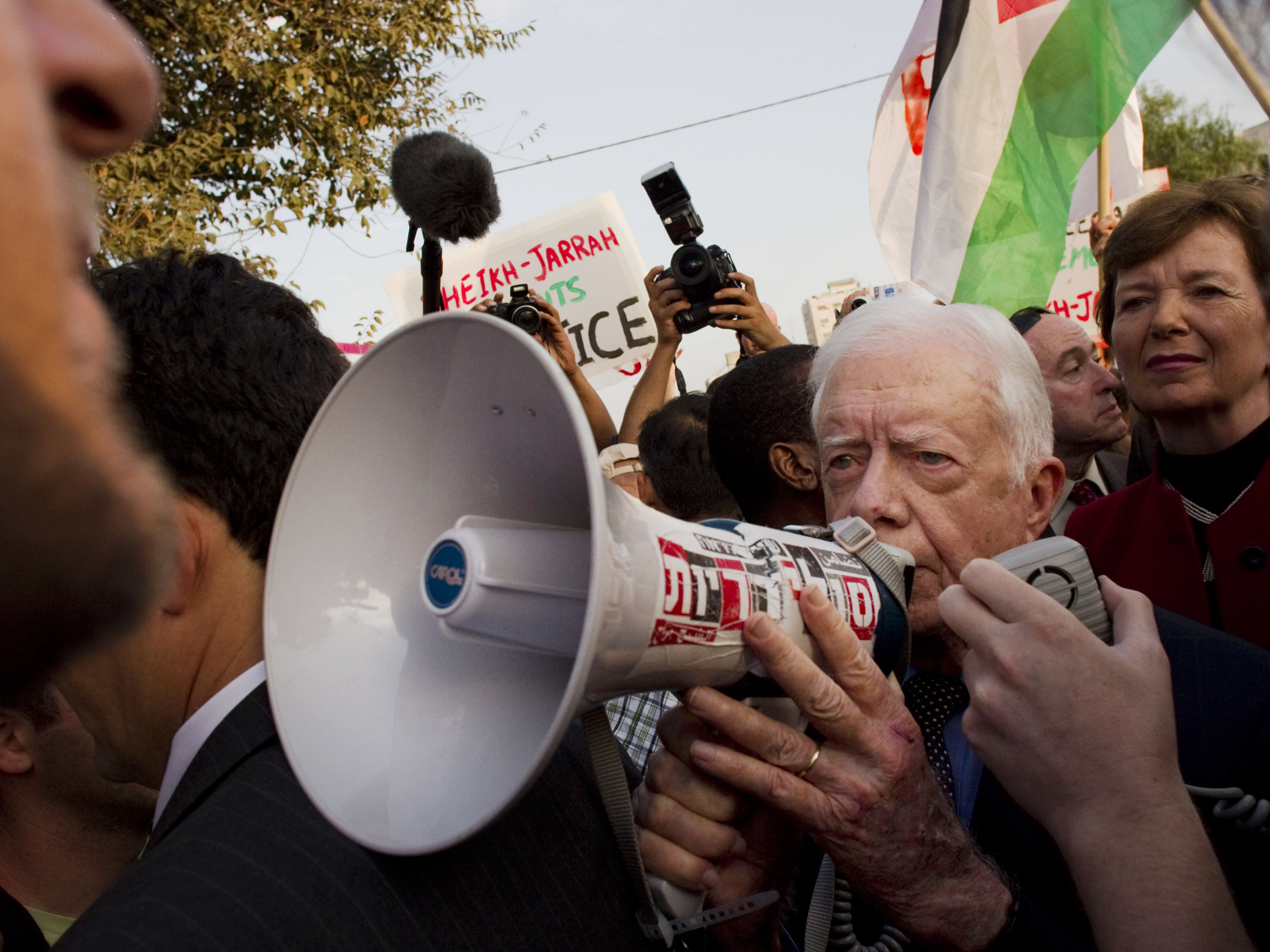 caption: October 22, 2010: former president of Ireland, Mary Robinson, background right, looks at former U.S. president, Jimmy Carter, center, while visiting a weekly protest in the east Jerusalem neighborhood of Sheikh Jarrah. The protest was organized by groups supporting Palestinians evicted from their homes in east Jerusalem by Israeli authorities.