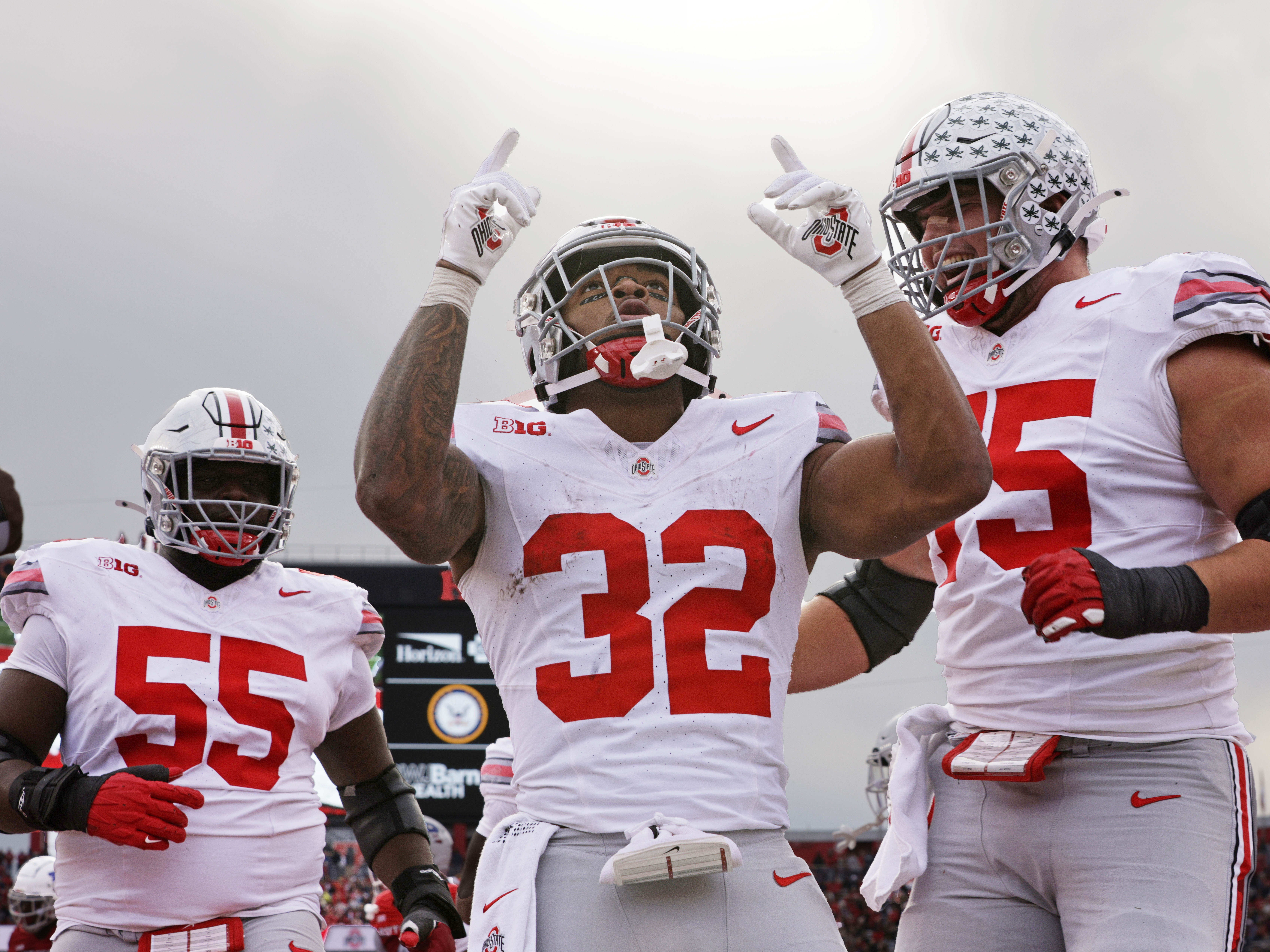 caption: TreVeyon Henderson, running back for the Ohio State Buckeyes, participated in what some are calling a Christian religious revival on campus. He's known for outward expressions of his faith, like citing Bible verses in his eye black.