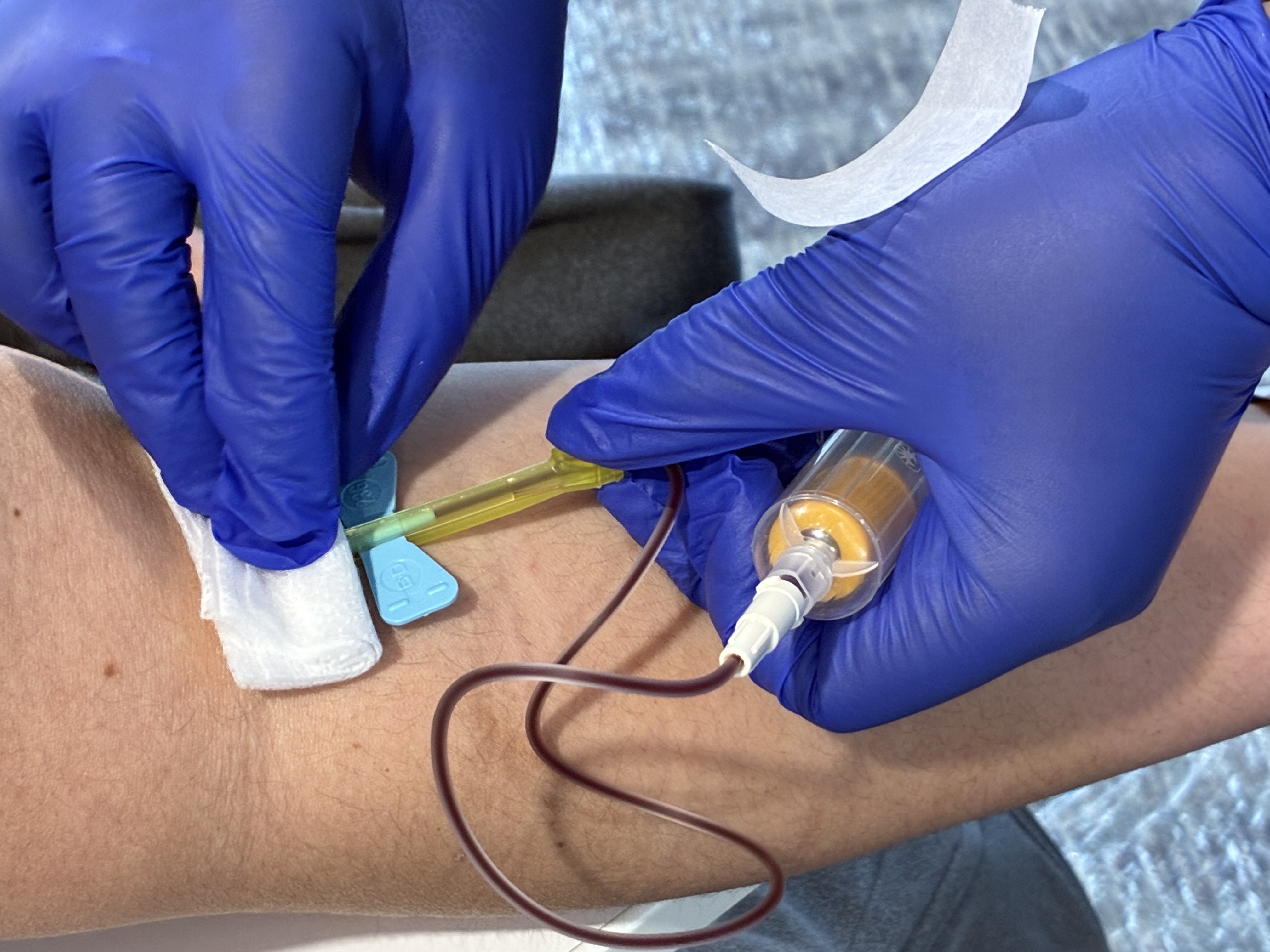caption: A volunteer phlebotomist draws blood from a patient at the Seattle/King County Clinic, April 23, 2026. This year more than 3,000 patients are expected to receive care. 