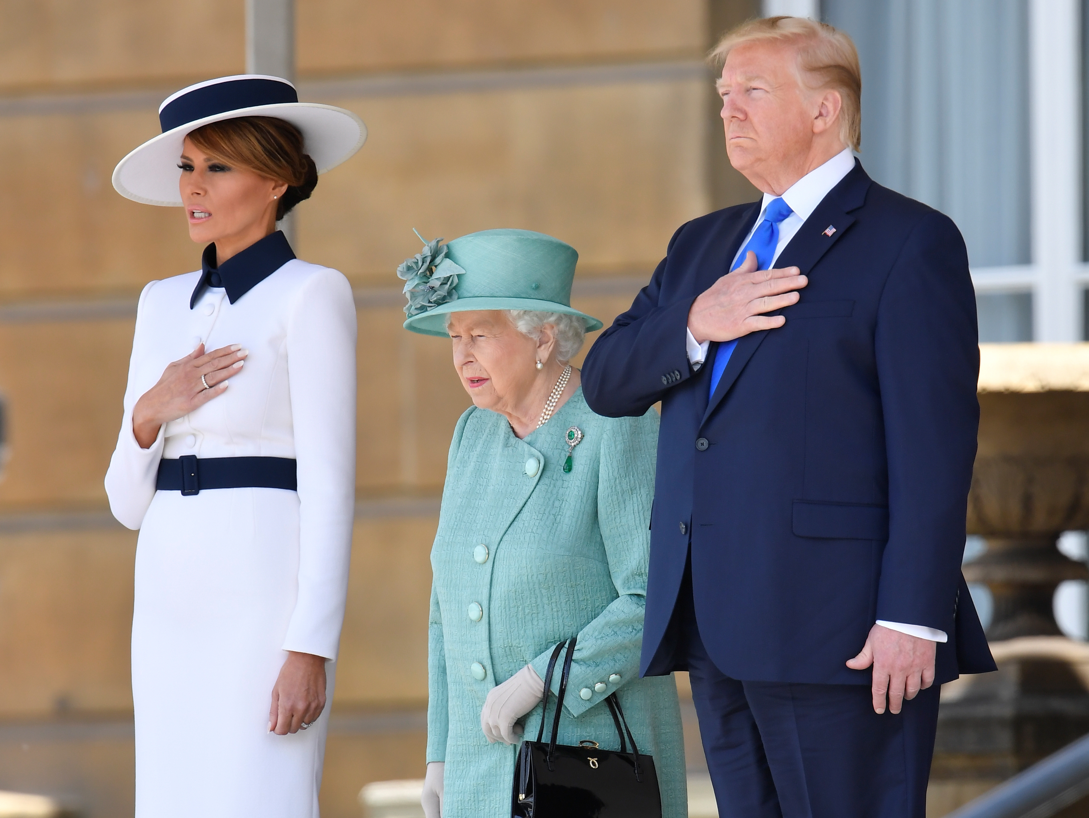 caption: President Trump and first lady Melania Trump were welcomed to the U.K. by Queen Elizabeth II in a ceremony Monday at Buckingham Palace.