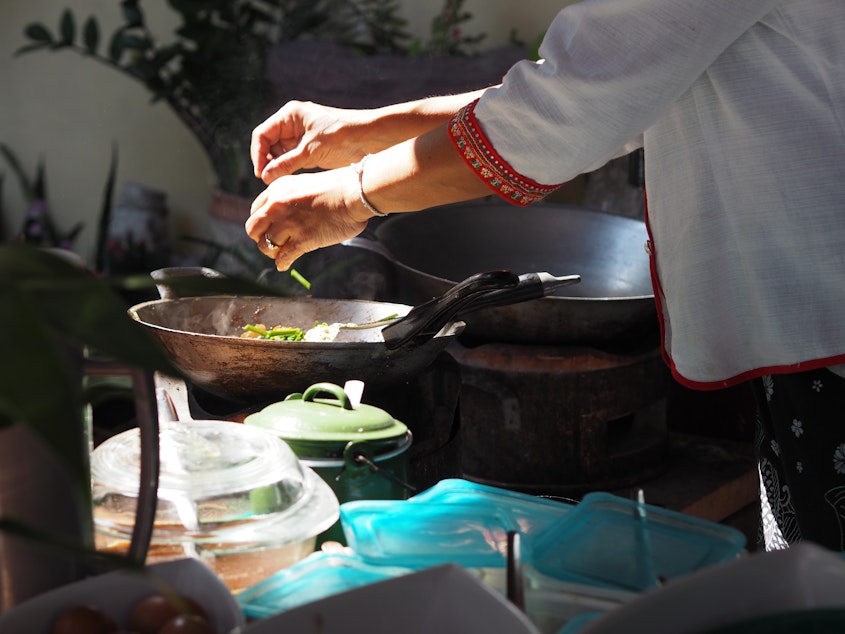 caption: Worldwide, women cook nearly 9 meals a week on average, while men cook only 4, according to a new survey.