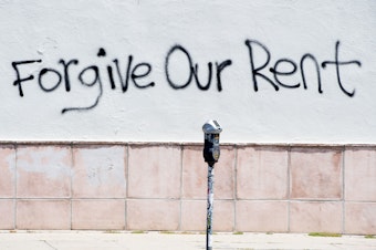 caption: Graffiti on a wall on La Brea Ave. in Los Angeles, Calif. asking for rent forgiveness in May. This week, the city of Los Angeles rolled out a renters relief program to provide more than $100 million in assistance.