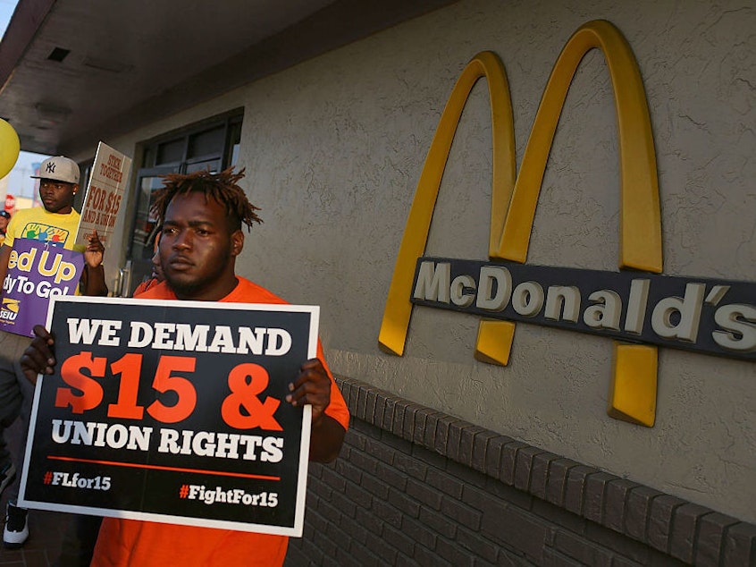 Demonstrators gather together at a McDonalds restaurant as they demand an increase in the minimum wage to $15 an hour on April 14, 2016 in Miami, Florida.