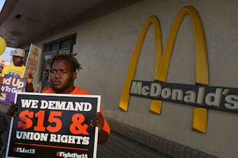 Demonstrators gather together at a McDonalds restaurant as they demand an increase in the minimum wage to $15 an hour on April 14, 2016 in Miami, Florida.
