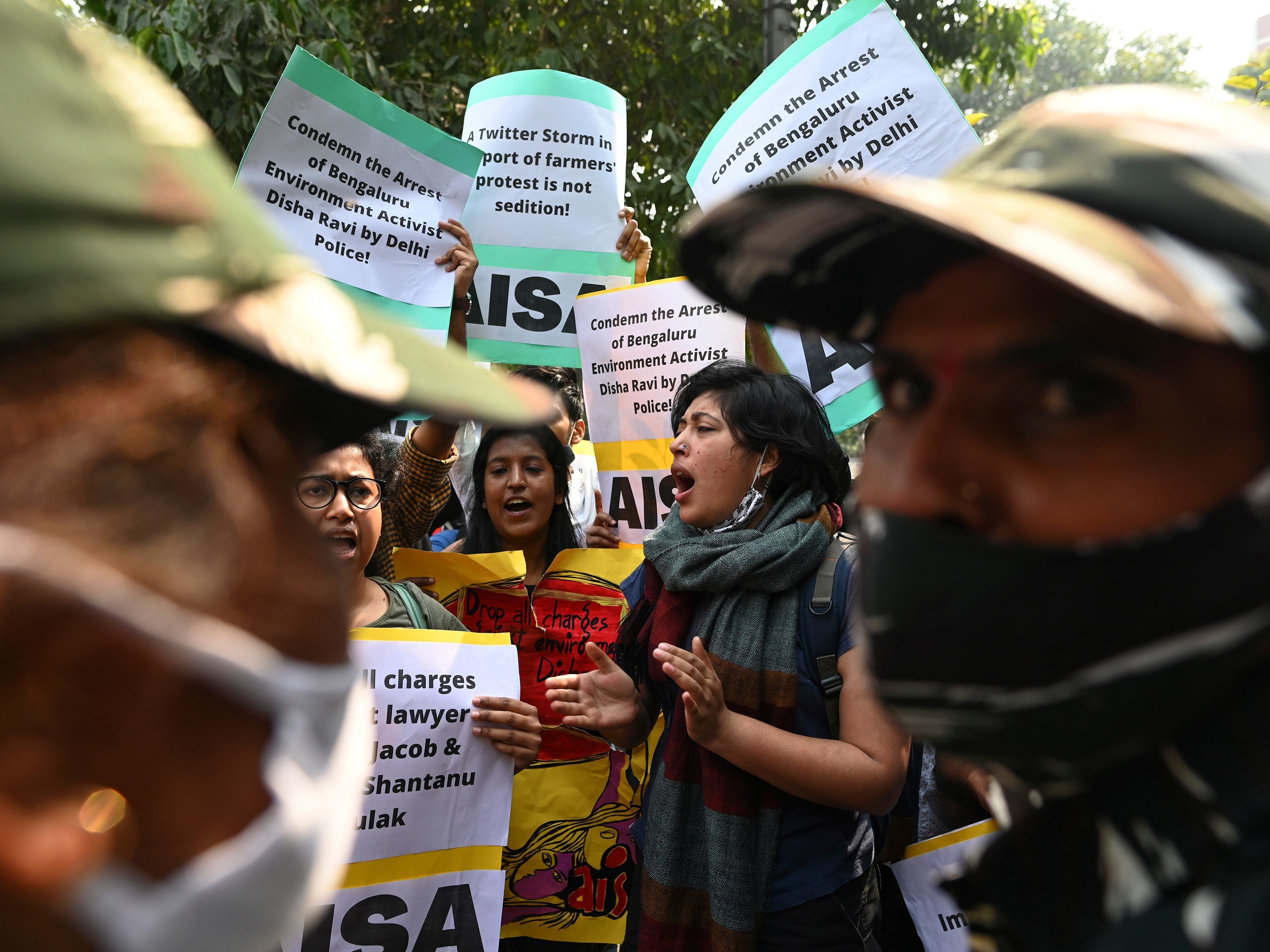 caption: Demonstrators in New Delhi shout slogans during a protest against the arrest of climate change activist Disha Ravi for allegedly helping to create a guide for anti-government farmers protests.