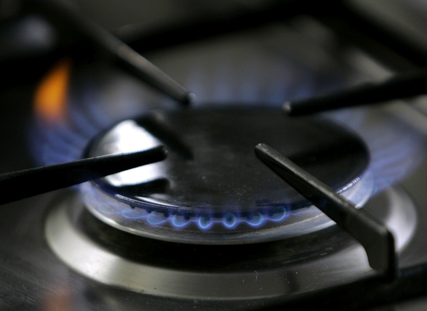 caption: A gas-lit flame burns on a natural gas stove. (Thomas Kienzle/AP)