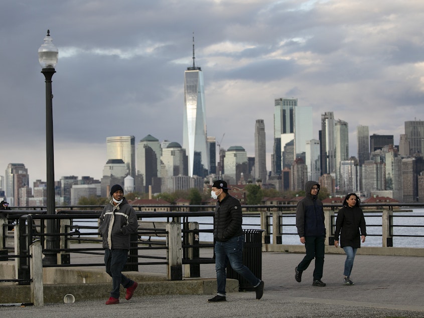 caption: New York City, as seen here from Jersey City, N.J. in May, is suing the Trump administration over its "anarchist" designation.