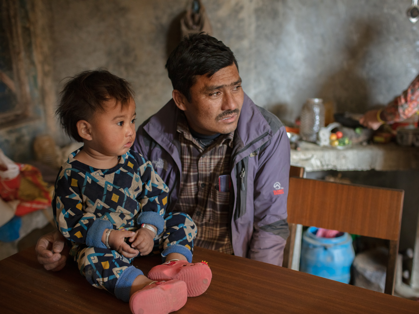caption: Married at 15, Chakraman Shreshta Balami fulfilled his dying father's wish by getting married — at age 15. He had to give up his dream of becoming a doctor. Now the vice principal of Sri Bhavani government school, he campaigns against child marriage — but even his son was married as a teenager. Above, he poses with a grandchild.
