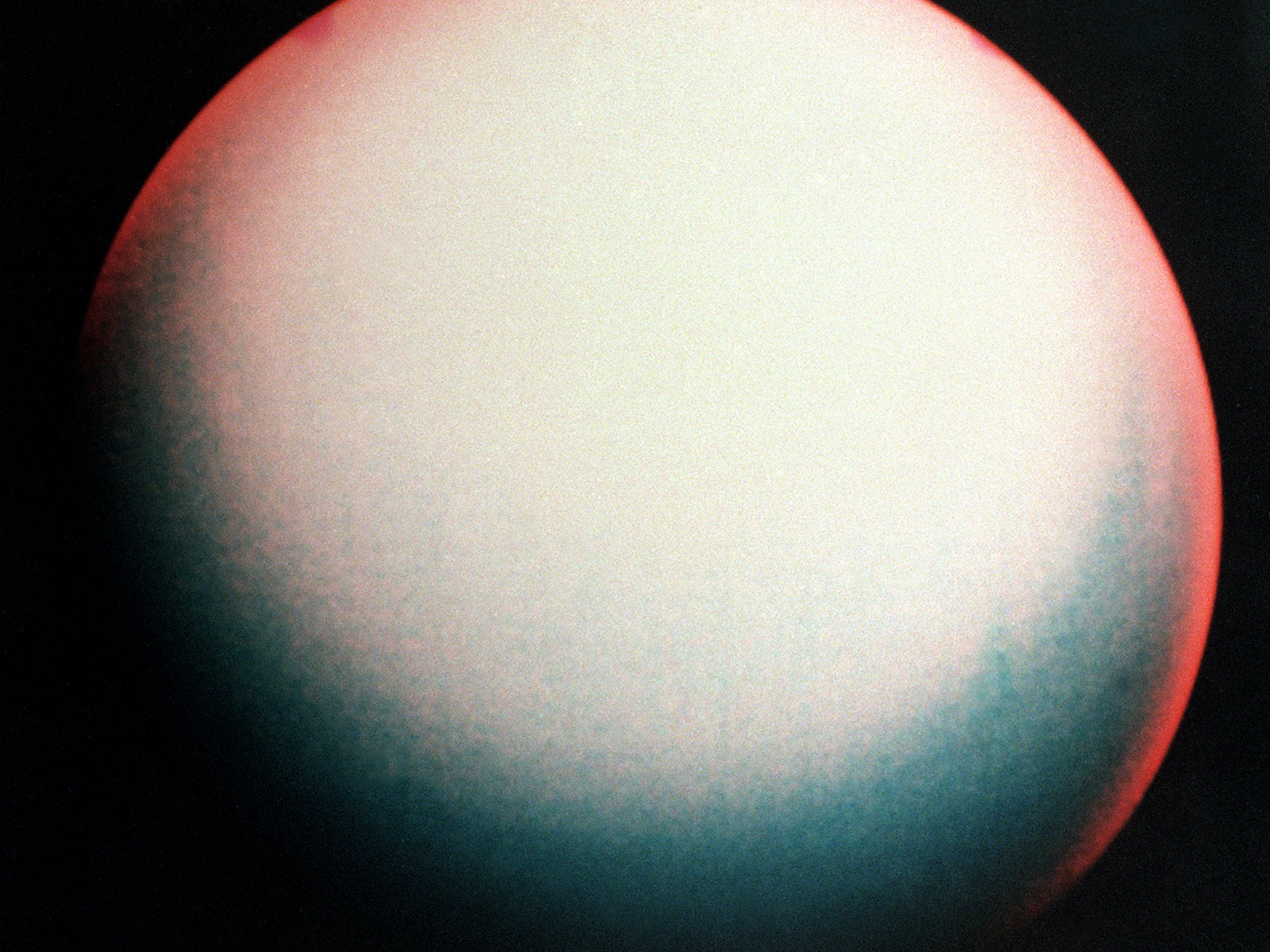 caption: A false color view of Uranus made from images taken by Voyager 2 in January 1986.