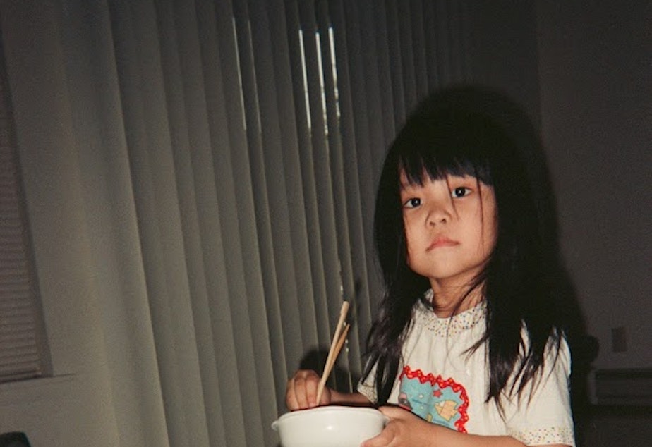 caption: Melissa Takai as a kindergartener eating a meal in her home. Takai says she remembers her mom spending a lot of time making her lunch every day, even though her mom was working multiple jobs to make ends meet.