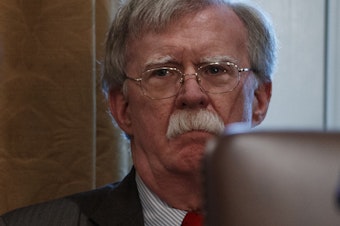 caption: John Bolton, then the national security adviser, listens as President Trump speaks during a Cabinet meeting in February. Bolton's opposition to a pressure campaign to get Ukraine to investigate conspiracy theories may pit him against his former boss.
