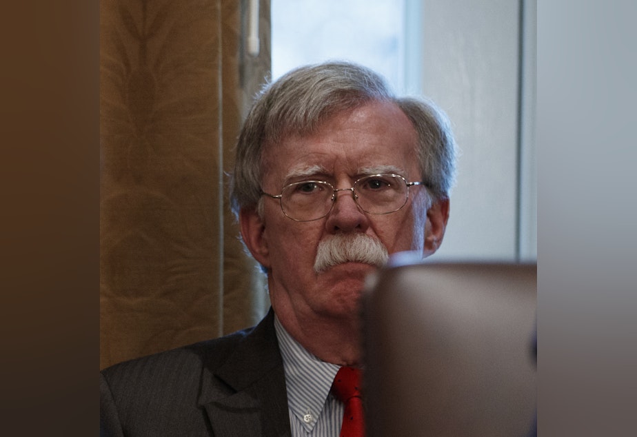 caption: John Bolton, then the national security adviser, listens as President Trump speaks during a Cabinet meeting in February. Bolton's opposition to a pressure campaign to get Ukraine to investigate conspiracy theories may pit him against his former boss.