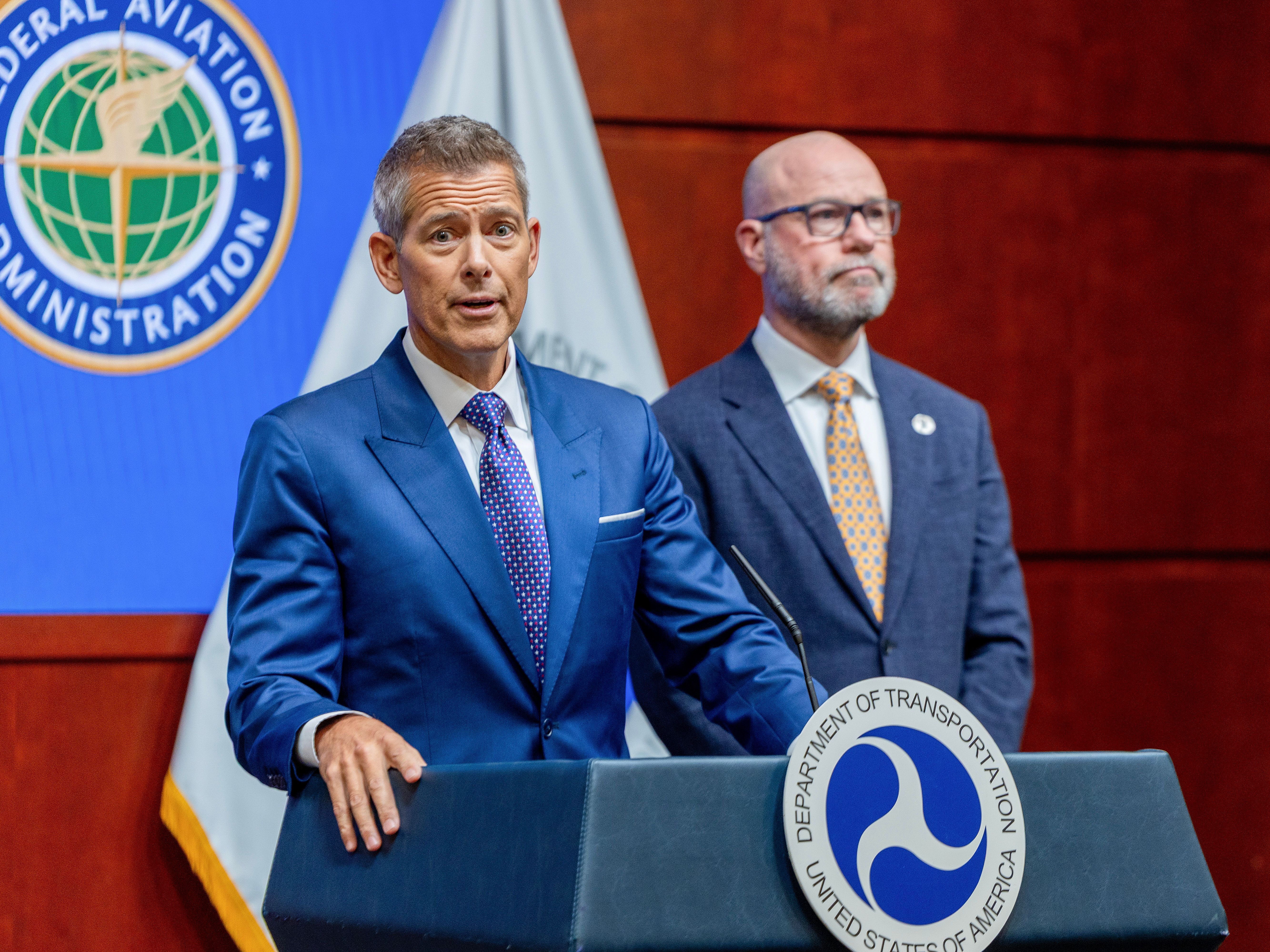 caption: U.S. Transportation Secretary Sean P. Duffy (left) and FAA Administrator Bryan Bedford announced Wednesday that the FAA will reduce air traffic at many busy airports to maintain safety during the government shutdown, which has led to staffing shortages of air traffic controllers.