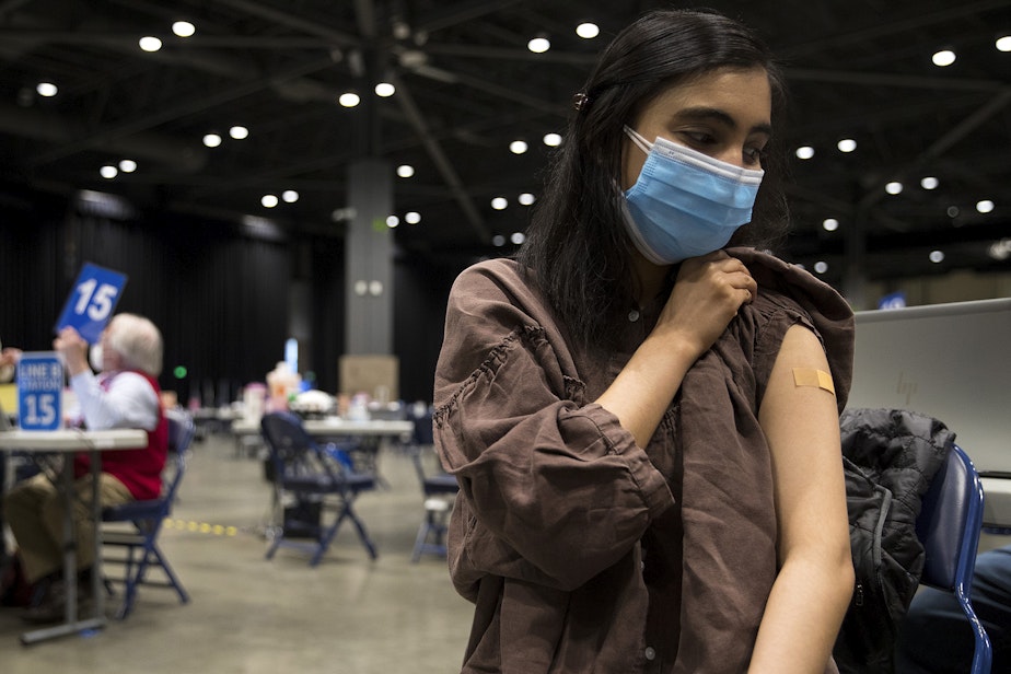caption: Shiva Sharma, 25, receives a Covid-19 vaccine on Thursday, April 15, 2021, at Lumen Field Event Center in Seattle. As of Thursday, anyone 16 years of age and older is eligible.