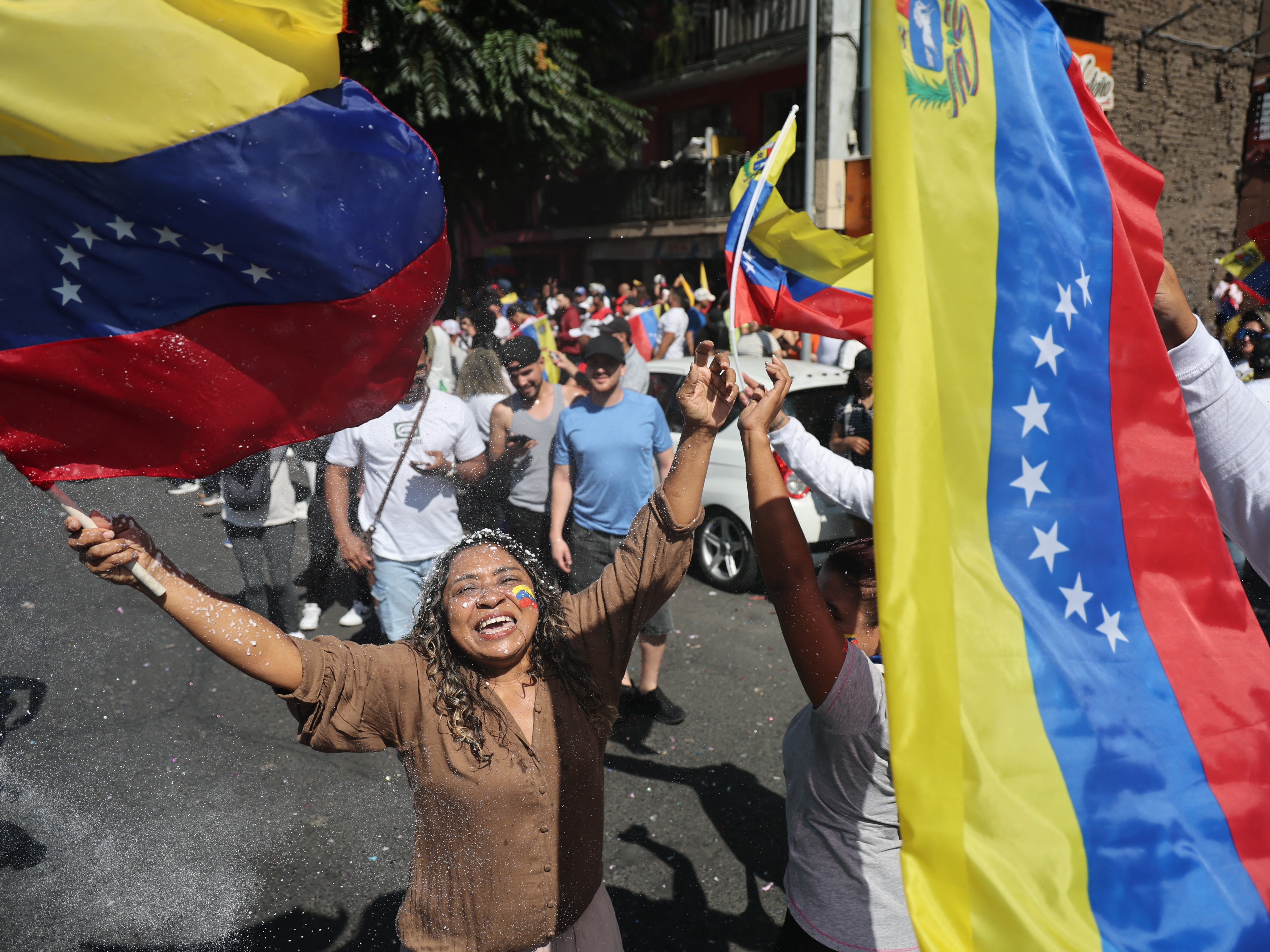 caption: Venezuelans living in Chile celebrate in Santiago on Jan. 3, 2026, after US forces captured Venezuelan leader Nicolas Maduro after launching a "large scale strike" on Venezuela.