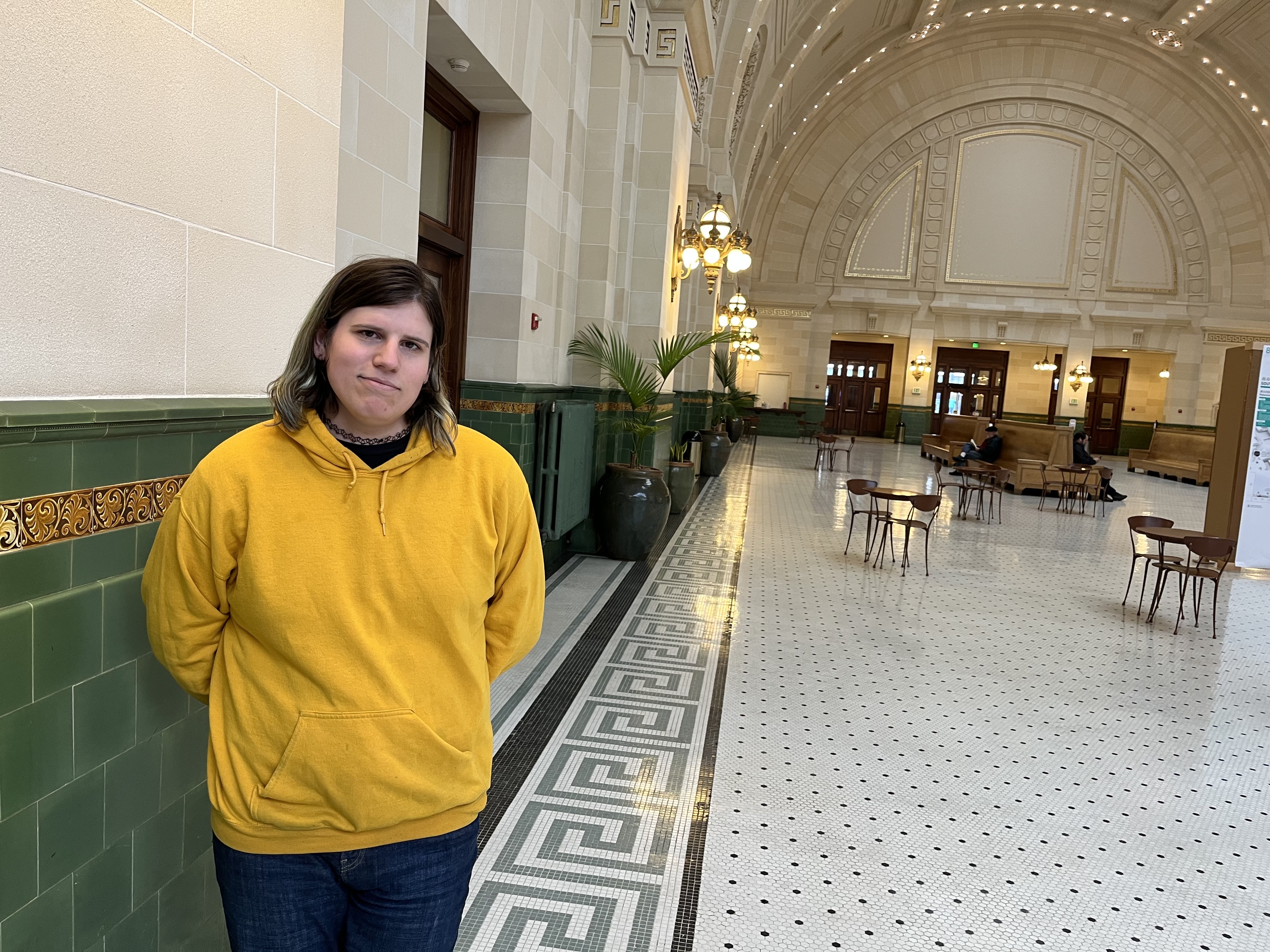 caption: Lexi Young, a transgender woman, works as a fare ambassador for Sound Transit. A Seattle man was charged with a hate crime assault against Young while she was working on Sept. 14, 2024. 