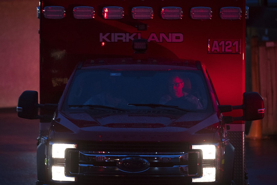 caption: Members of the Kirkland Fire Department arrive at the Life Care Center of Kirkland on Monday, March 2, 2020, to transport a patient to the hospital.