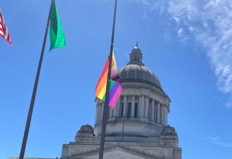 caption: A new, more inclusive Pride flag debuts at the Washington Capitol in Olympia on Tuesday, June 21, 2022. 