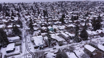 caption: Homes are shown blanketed in snow on Tuesday, Dec. 20, 2022, in the Ballard neighborhood of Seattle. 