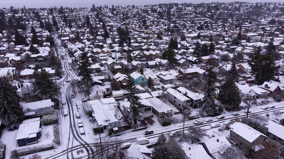 caption: Homes are shown blanketed in snow on Tuesday, Dec. 20, 2022, in the Ballard neighborhood of Seattle. 