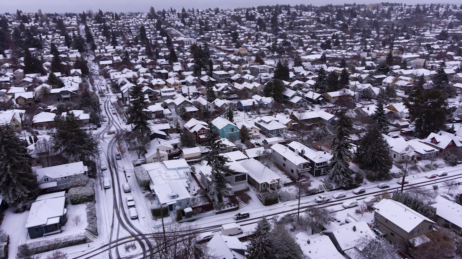 caption: Homes are shown blanketed in snow on Tuesday, Dec. 20, 2022, in the Ballard neighborhood of Seattle.