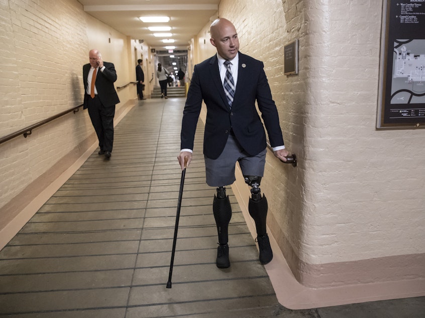 caption: Rep. Brian Mast, R-Fla., walks to a meeting in the Capitol in Washington in June 2018. Mast and other members of Congress are appealing a decision by the Department of Veterans Affairs to evict them from office spaces at VA hospitals.