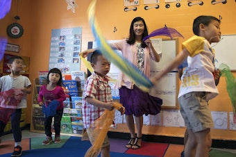caption: Seattle Preschool Program teacher Hien Do dances with her students on June 28, 2017, at the ReWA Beacon Hill Early Learning Center in Seattle.