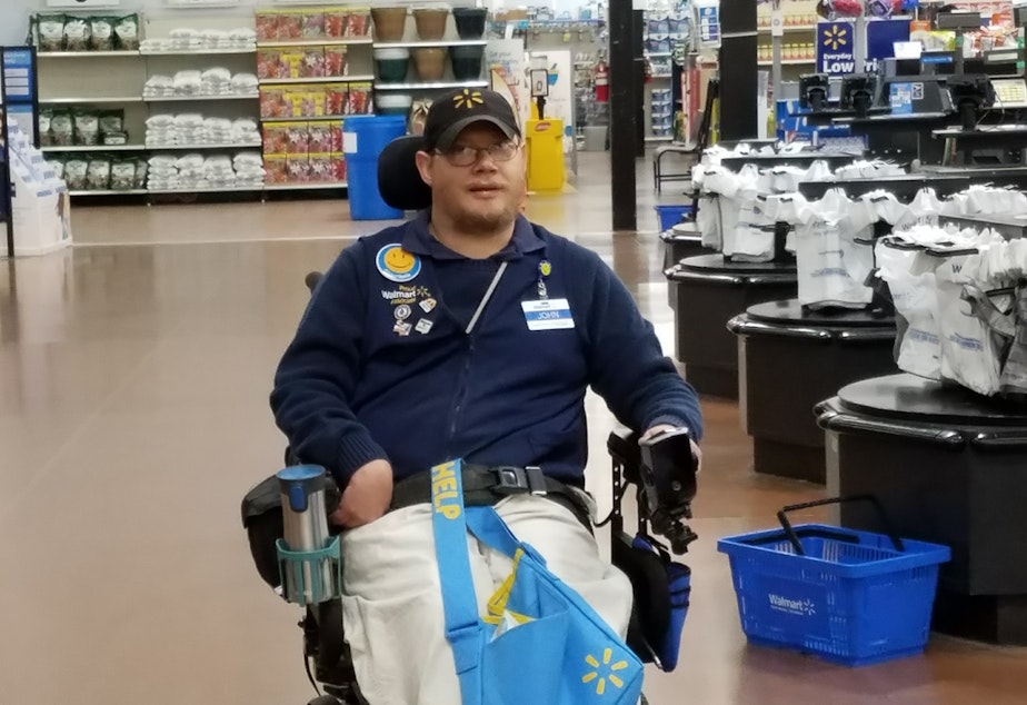 caption: John Combs is a "people greeter" at a Walmart in Vancouver, Wash. But he has been told that come April 25, his job is going away. And he is not alone.