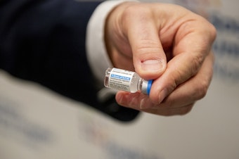 caption: A health care worker holds a vial of the Johnson & Johnson COVID-19 vaccine at South Shore University Hospital in Bay Shore, N.Y., on Wednesday.