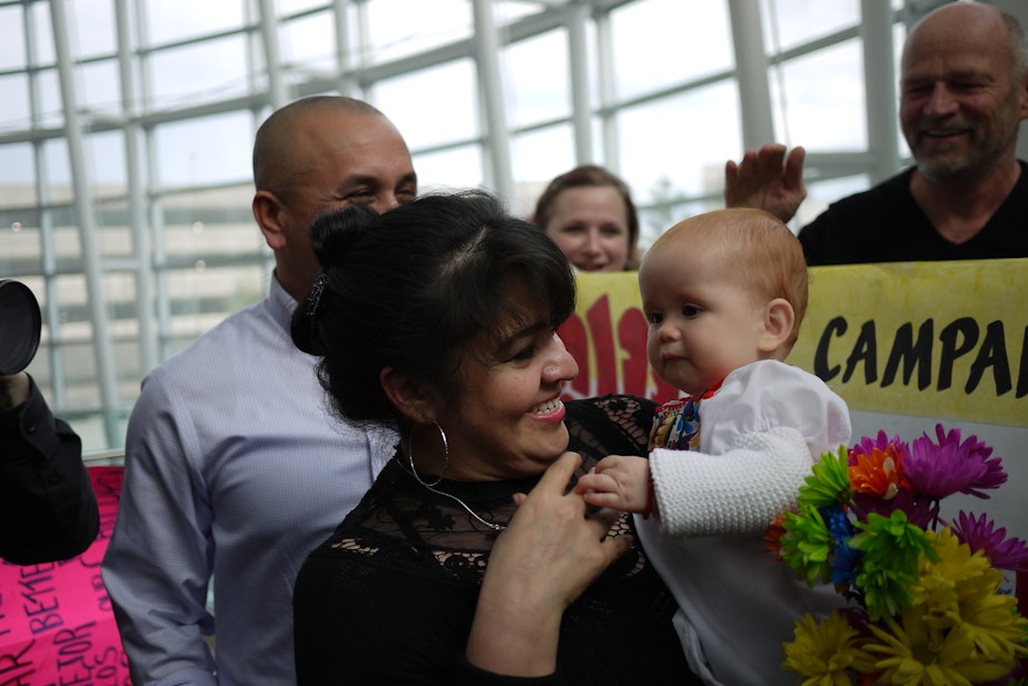 caption: Nestora Salgado, an activist from Renton who was imprisoned in Mexico, spoke with supporters upon arrival at Sea-Tac Airport. Some people handed her their babies.