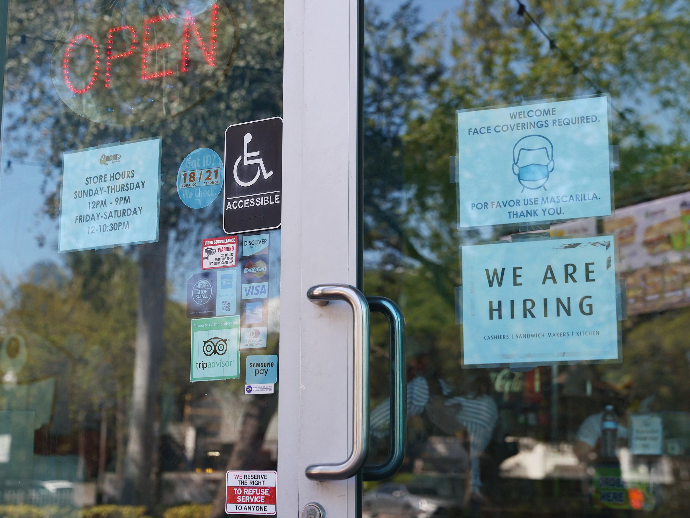 caption: A 'we are hiring' sign in front of a store in Miami, Florida. Restaurants and other in-person business are looking to hire more workers as the U.S. jobless rate continues to fall.
