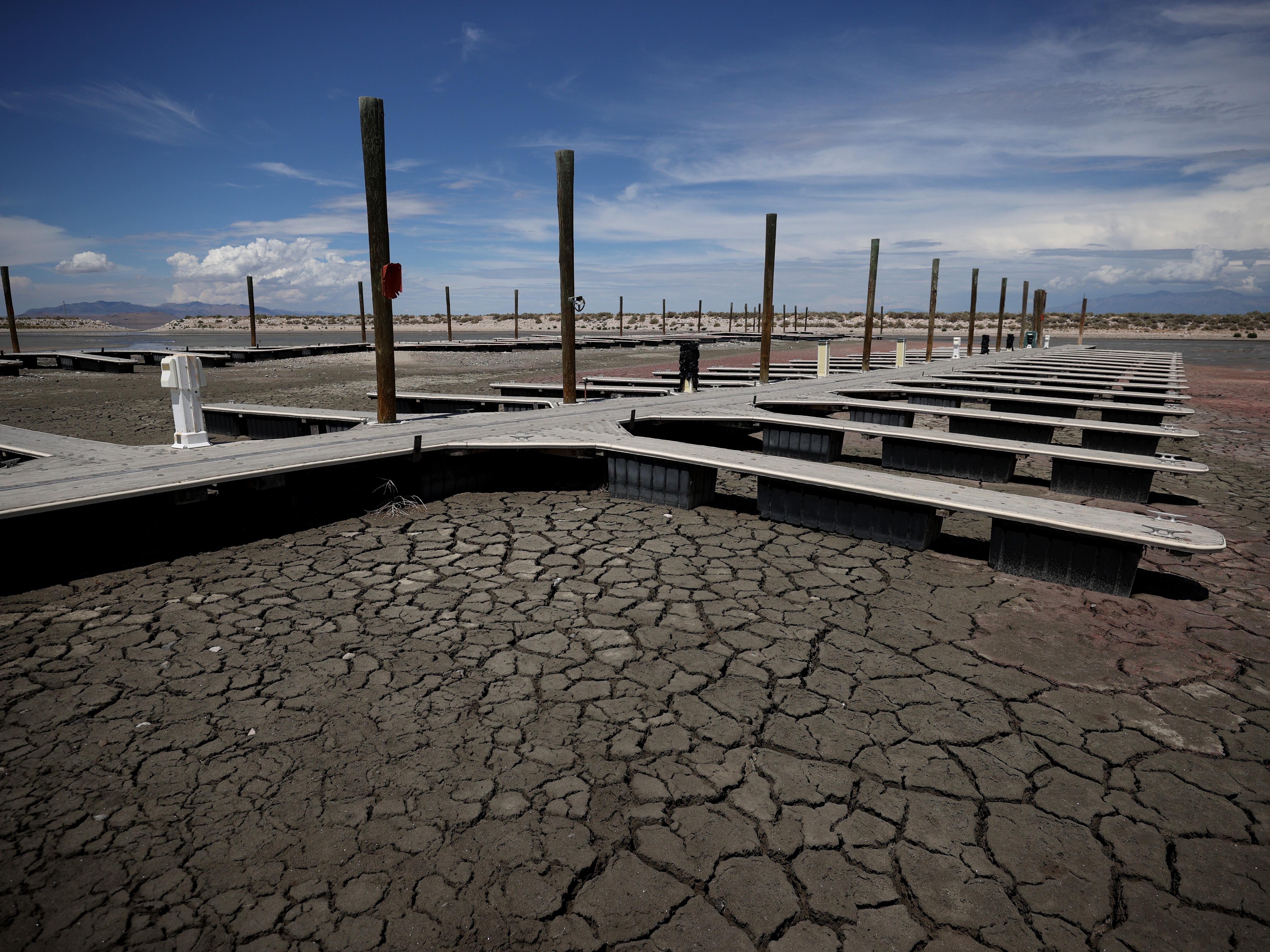 caption: Boat docks sit on dry cracked earth at the Great Salt Lake's Antelope Island Marina in 2021 near Syracuse, Utah.