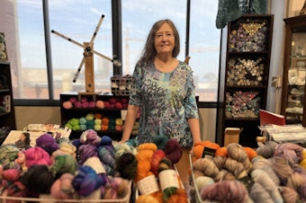 caption: Betty Clune displays yarns made by local dyers at her store, "So Much Yarn."