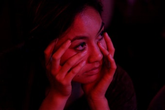 caption: Tracey Tran of Seattle was with friends at The Comet watching election results Tuesday night.