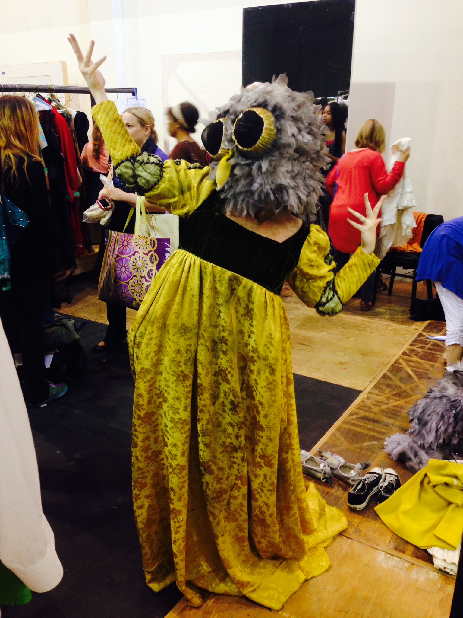 caption: Melinda Rose models the head of an owl costume from the Seattle Opera's Rusalka. The rest of the costume was too small.